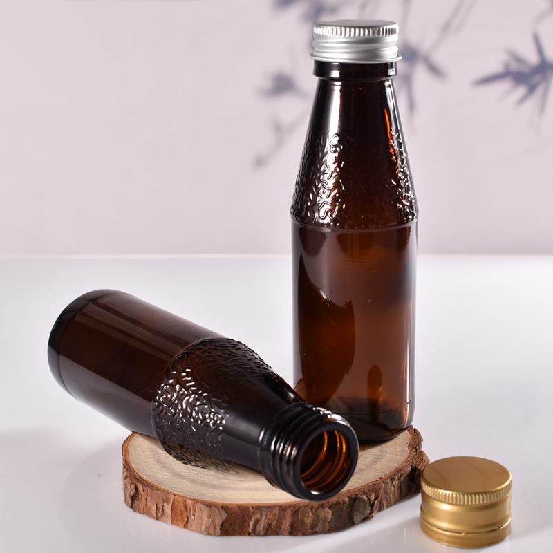 Fabricante de botellas de jarabe de vidrio ámbar recicladas de vidrio selladas de 100 ml con tapa de metal