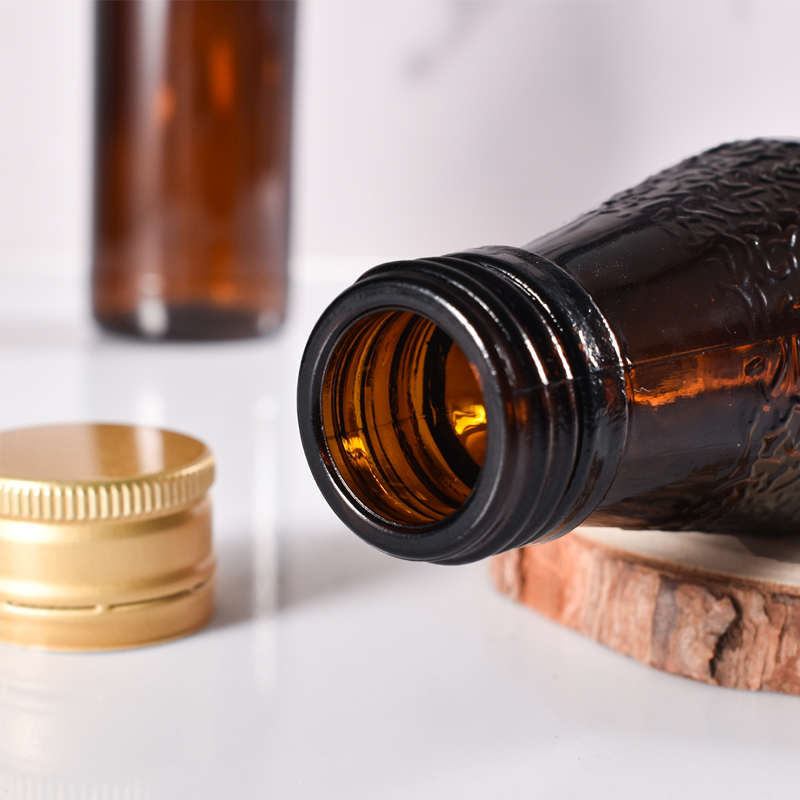 Fabricante de botellas de jarabe de vidrio ámbar recicladas de vidrio selladas de 100 ml con tapa de metal