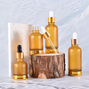 Botella de aceite esencial de vidrio con fondo dorado euro de 25 ml, 35 ml y 50 ml con tapa dorada
