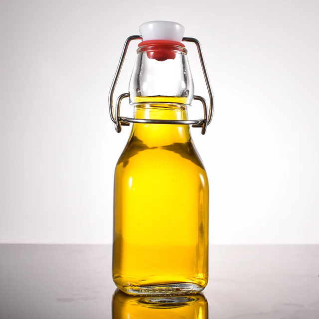 Botellas de vidrio con tapa abatible transparente de 120 ml