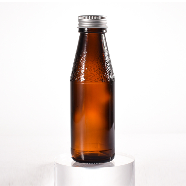 Fabricante de botellas de jarabe de vidrio ámbar recicladas de vidrio selladas de 100 ml con tapa de metal